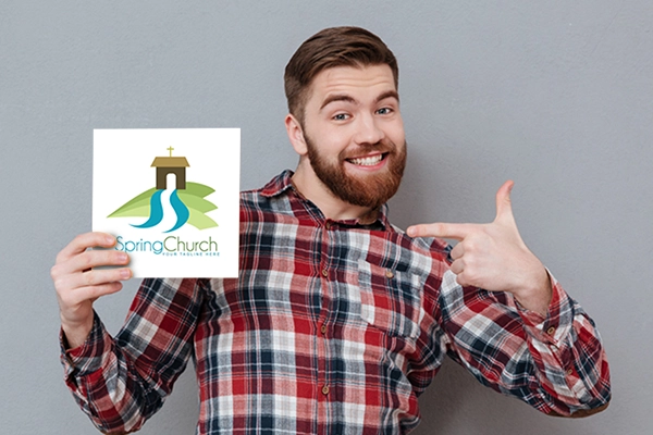 Mockup of man holding Spring Church Logo
