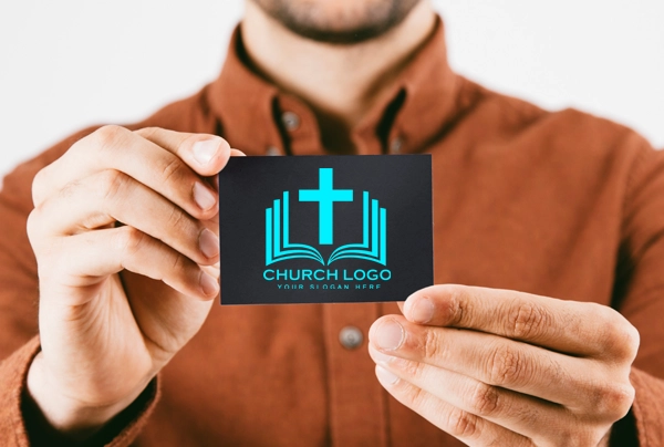 Man holding picture of church logo business card