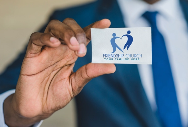 Picture of man holding Friendship Church business card
